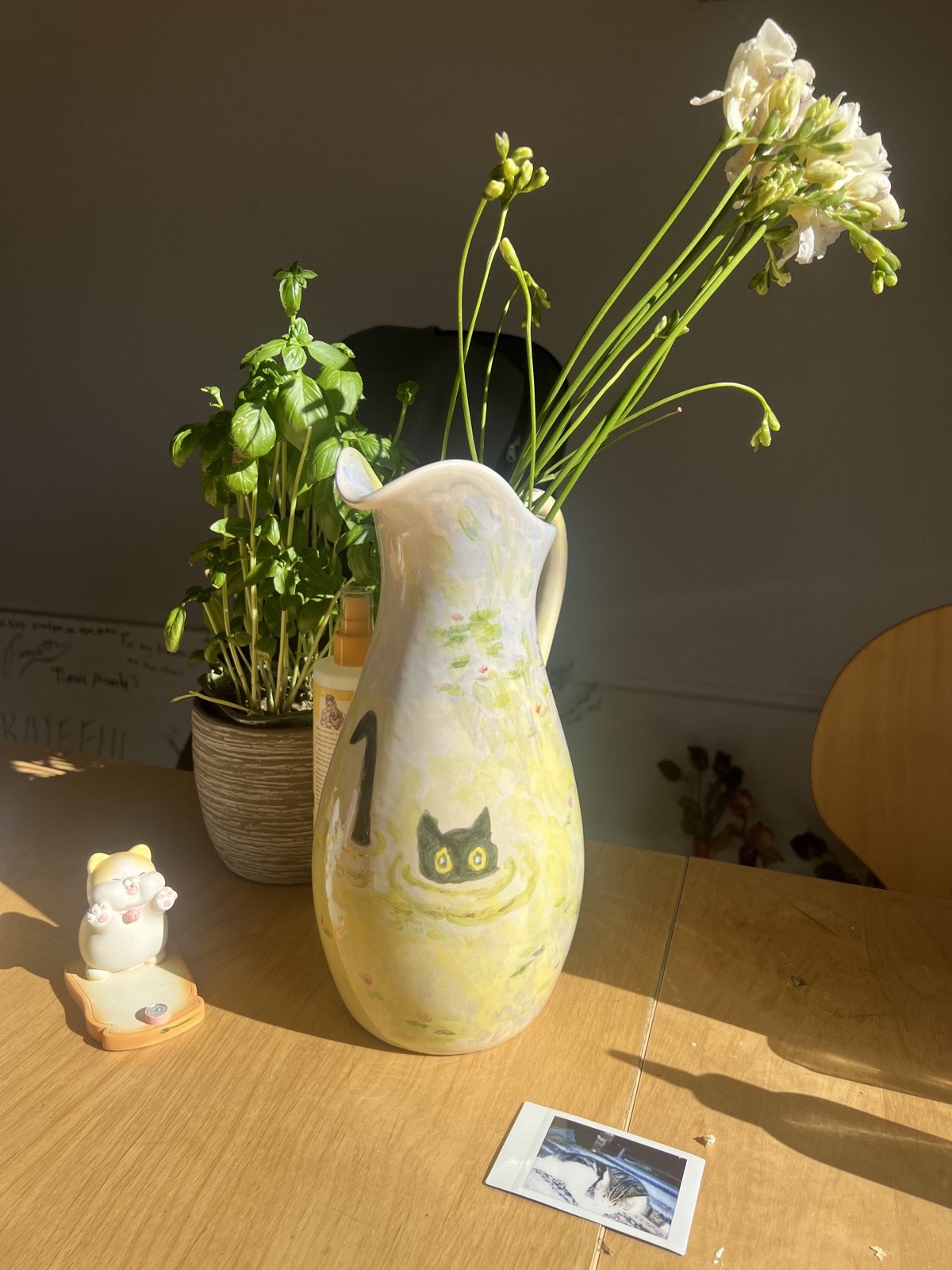 Painting: A cat in the lily pond, on a pitcher